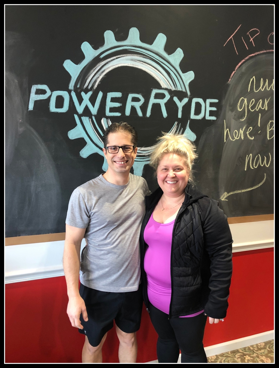 Stephanie and Michael Craig in front of chalk PowerRyde logo